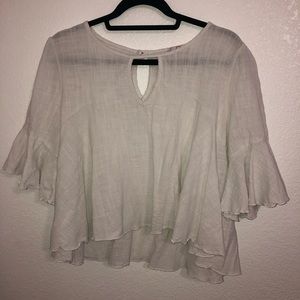 Sheer white peasant shirt, slightly cropped.